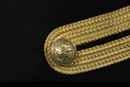 Ensemble polytechnique. Claque (bicorne) dans sa boite d'origine, tangente (épée) boucle de ceinturon et 2 boutons.