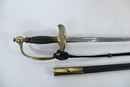 Ensemble polytechnique. Claque (bicorne) dans sa boite d'origine, tangente (épée) boucle de ceinturon et 2 boutons.