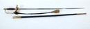 Ensemble polytechnique. Claque (bicorne) dans sa boite d'origine, tangente (épée) boucle de ceinturon et 2 boutons.