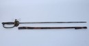 Épée d'officier subalterne, modèle 1857, clavier à l'aigle demi déployé, fourreau en 2 morceaux.